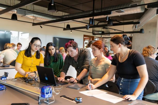 Group of women looking at a computer during class