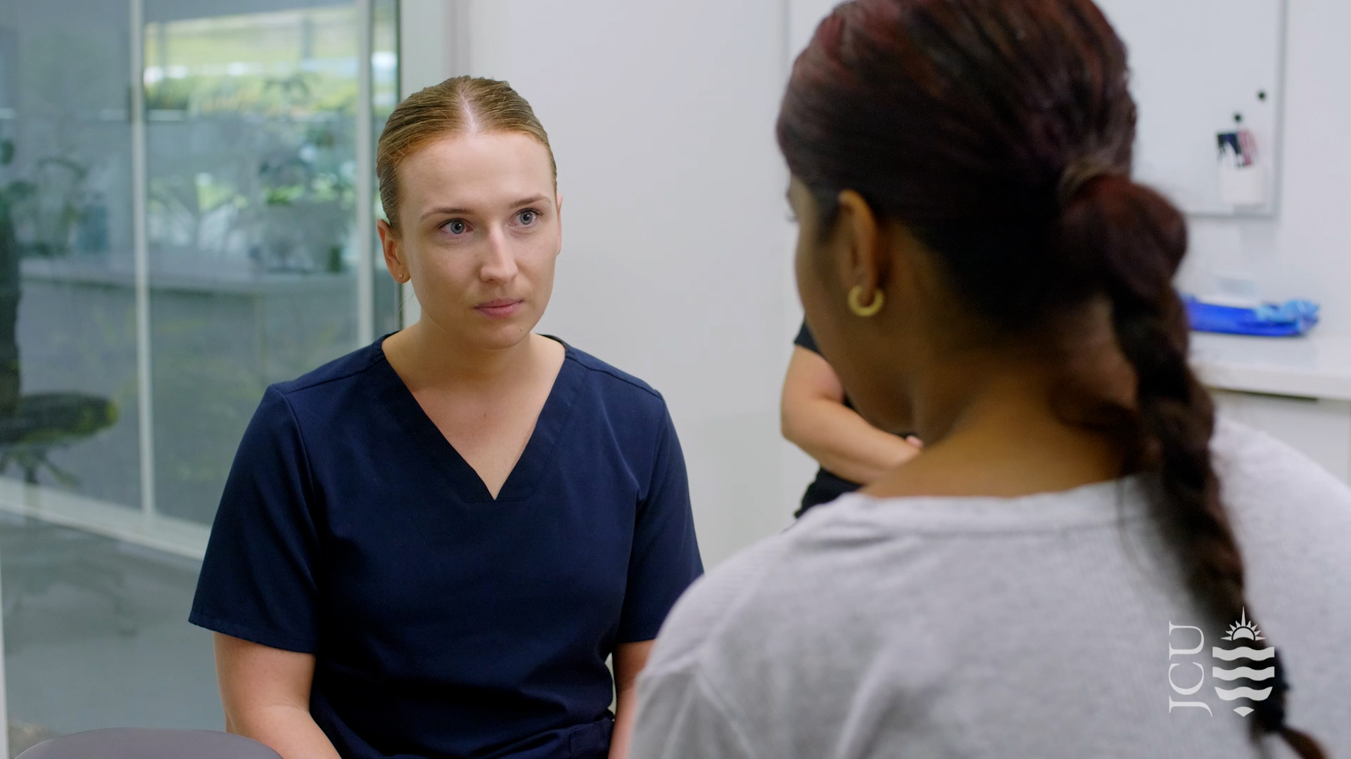 dentist talking to patient in office.