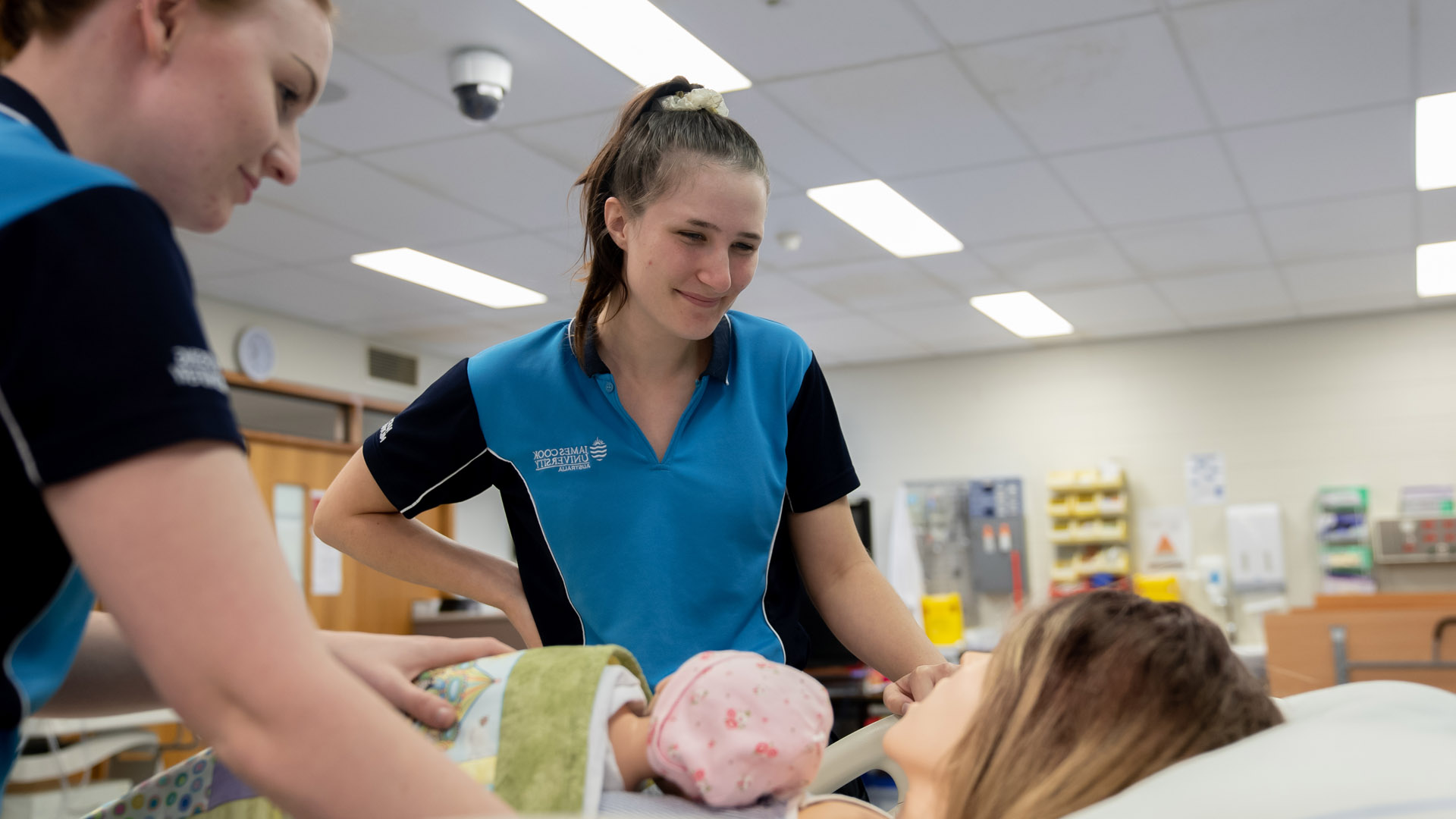 Two JCU Midwifery students practice their skills in a simulated maternity ward. 