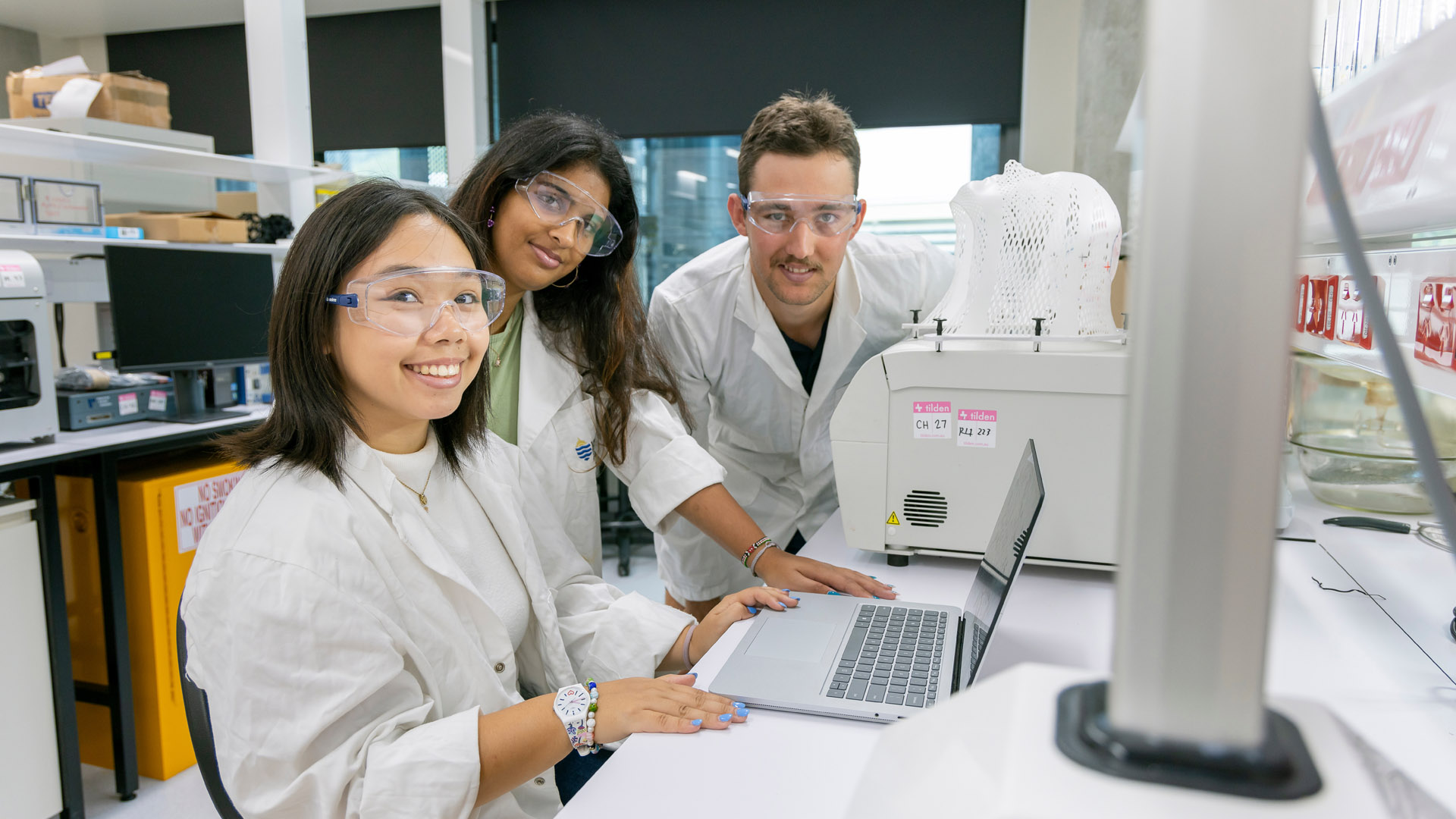 JCU students collaborate at a computer in a laboratory. 