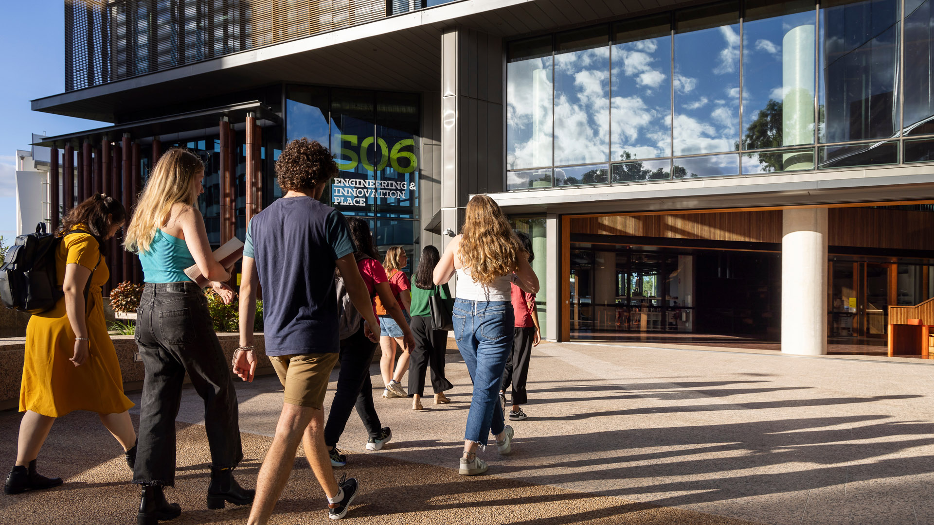 JCU students walk across the Townsville Bebegu Yumba campus towards the Engineering and Innovation Place building. 