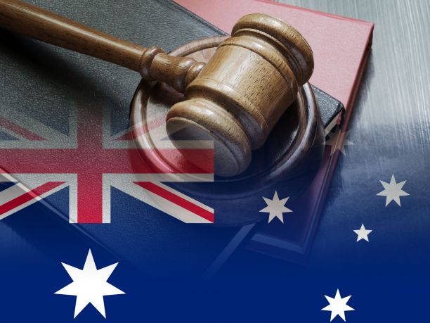 An image of an Australian flag with the judge's gavel. 